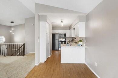 White, bright galley kitchen with pantry.