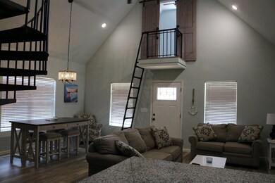Living room featuring high vaulted ceiling, an inv