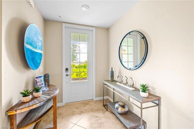 Entryway with light tile patterned flooring and baseboards