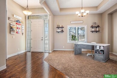 Wood floors in foyer and carpet in dining, spacious with cut out for credenza/buffet, etc.