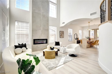 Living area with a high ceiling, arched walkways,