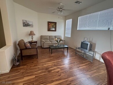 Living room with visible vents, wood finished floo