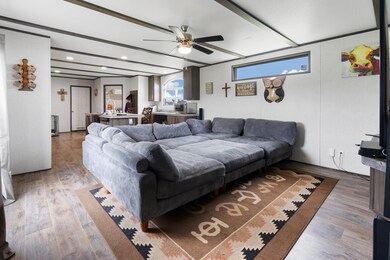 Living room featuring a ceiling fan, light wood-style floors, and recessed lighting