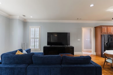Living room with light wood-type flooring and orna