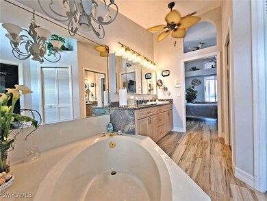 Full bathroom with a washtub, ceiling fan with not