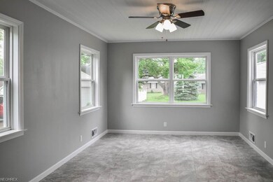 Family room with crown molding and a half bath.
