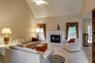 Spacious great room with vaulted ceiling with fan for the warm summers  and a cozy fireplace to welcome fall.