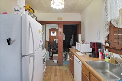 Galley kitchen with brand new refrigerator, dishwa