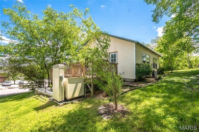 View of home's exterior featuring a yard and a wooden deck