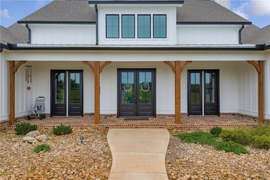 Doorway to property with roof with shingles, cover