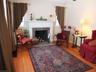 Living room with hardwood floor and fireplace.