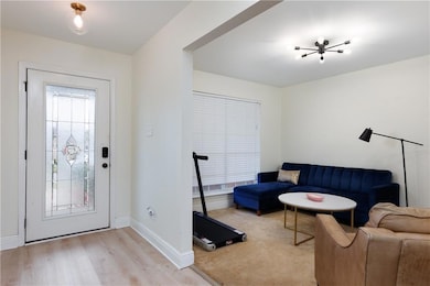 Entryway with light wood-type flooring and baseboards