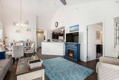 Living room with high vaulted ceiling, a chandelie
