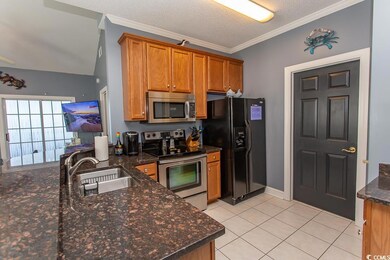 Kitchen with ornamental molding, a textured ceilin