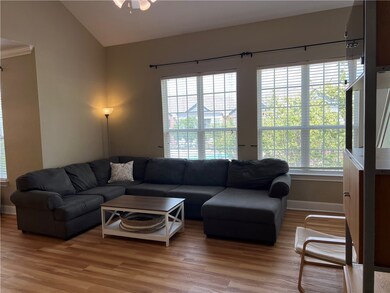 Living room featuring wood-type flooring and lofte