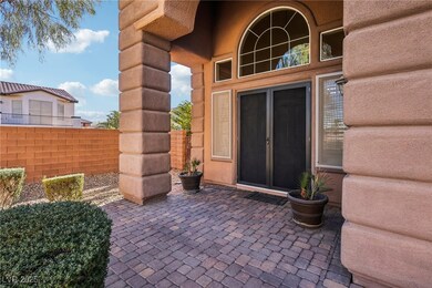 Entrance to property featuring a patio area and fe