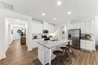 Kitchen featuring white cabinetry, dark wood-type 