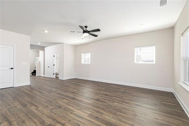 Spare room featuring dark wood-style floors, ceiling fan, and recessed lighting