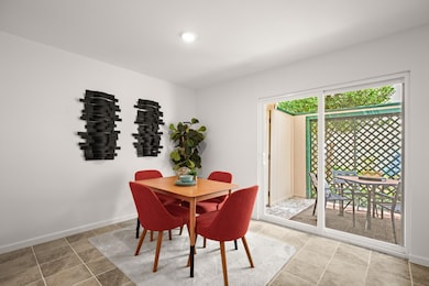 Tiled dining room featuring baseboards and recess