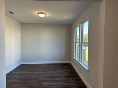 Empty room featuring dark hardwood / wood-style fl