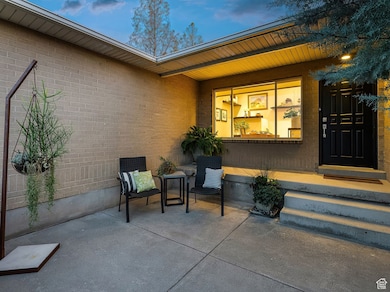 View of exterior entry with brick siding