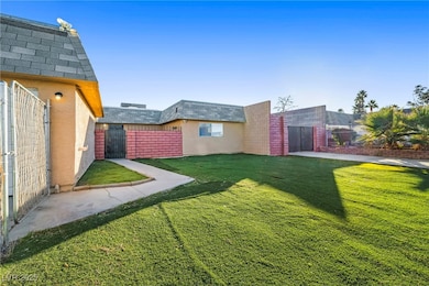 Fenced backyard featuring a gate