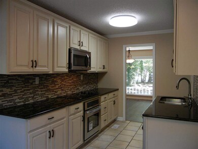 This gorgeous kitchen has granite counter tops, custom cabinets, beautiful glass backsplash and stainless steel appliances. Appliances included are cooktop, oven, dishwasher, and microwave.