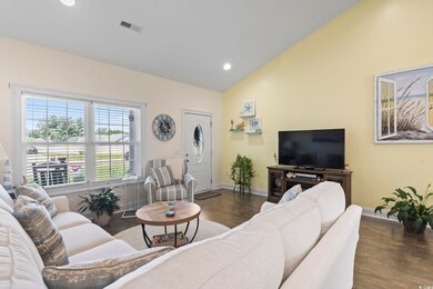 Living room with high vaulted ceiling and dark woo