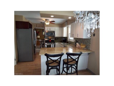 Newly remodeled kitchen has granite counters, stai