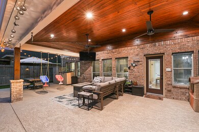 Just look at this beautiful craftsmanship and woodwork! Stunning !Covered back patio , great for relaxing, playing, or enjoying TV time. This Outdoor living space also offers a dual ceiling fans and recessed light to enjoy anytime day or night.
