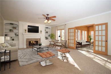 Updated white built-ins with cozy fireplace. Frenc