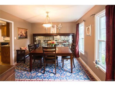 Formal dining room with hardwood floors.