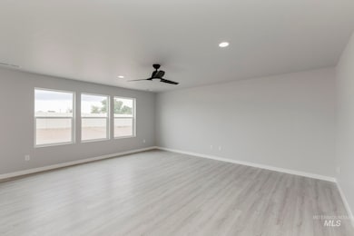 Unfurnished room featuring light wood-style floors, recessed lighting, and ceiling fan
