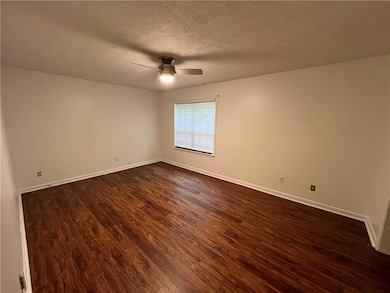 Unfurnished room with baseboards, ceiling fan, and