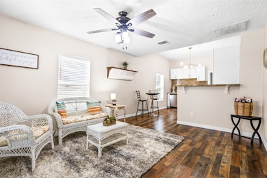 Step into an updated home that starts in this living area with wood flooring.