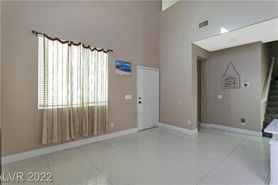 Family room with a high ceiling, stairs, baseboard