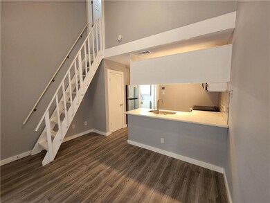 Unfurnished living room featuring dark wood-style