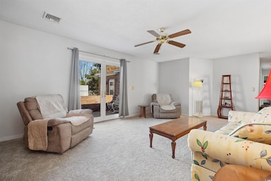 Living room with baseboards, visible vents, a ceil