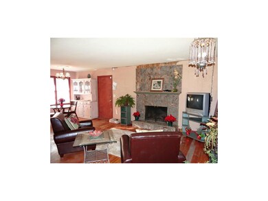 The Open Great Room With Marble Fireplace & Hardwo