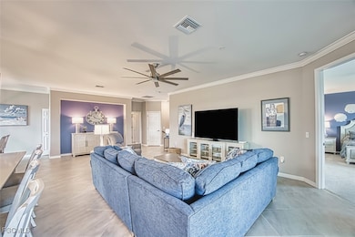 Living area featuring crown molding and ceiling fan