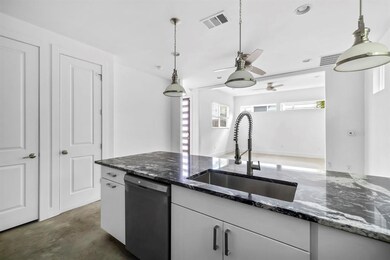 Kitchen with dishwashing machine, a sink, a ceili