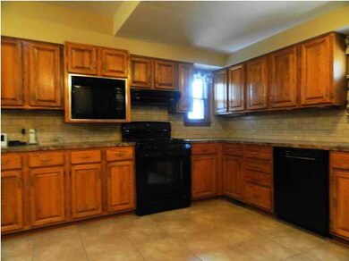KITCHEN W/OAK WOOD CABINETS AND TILE FLOORING