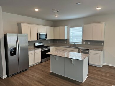 Kitchen featuring backsplash, appliances with stai