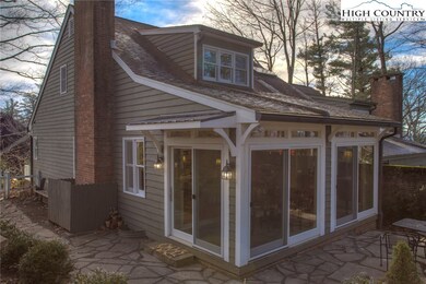 Step outside of the sun room onto the stone patio.
