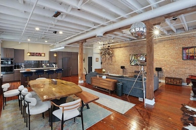 Exposed beams and exposed brick provide an artist'