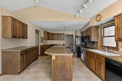 Enjoy an open kitchen with vaulted ceilings, granite counters, a huge center island, plenty of cabinets for storage of your kitchen essentials, and ample counter space for food prep or buffet style meals on the breakfast bar.