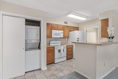 Kitchen featuring light tile patterned flooring, l