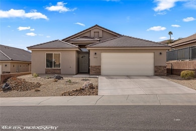 Ranch-style home featuring stucco siding, stone si