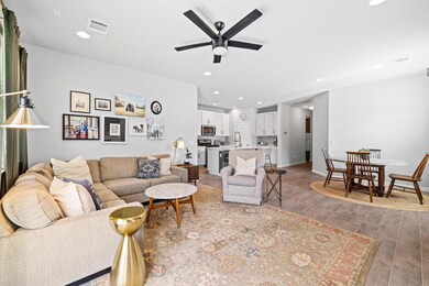 Living room with a ceiling fan, wood finished flo