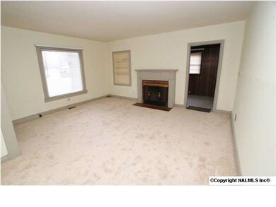 Family room with new carpet, fireplace and picture window